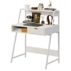 A white computer desk with a shelf and a drawer, decorated with various items. Produktbild-Vorschau