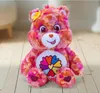 A plush toy bear sitting on a wooden floor. Anteprima dell’immagine prodotto
