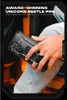 A person is holding a black phone case with a kickstand in a car. Produktbild-Vorschau