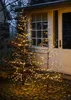 Two illuminated LED trees are placed outside a building at dusk. Produktbild-Vorschau