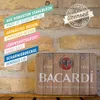 A vintage-style metal tin with the Bacardi logo, set against a stone wall background. Podgląd zdjęcia produktu