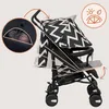 A baby is shown in a stroller with a zigzag pattern canopy. The stroller is shown from the side with diagrams indicating adjustable features. Náhled obrázku produktu