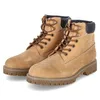 A pair of tan work boots with brown laces and black trim on a white background. Produktbild-Vorschau