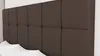 A close-up view of a brown upholstered headboard with white pillows in the foreground. Produktbild-Vorschau