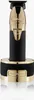 A professional studio shot of a gold and black hair trimmer on a white background. Voir les images du produit