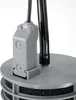 Close-up of a gray plastic component with black tubes attached, sitting on a gray circular base with black filter material. Produktbild-Vorschau