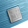A close-up of a blue textured surface with a silver logo plate. Anteprima dell’immagine prodotto