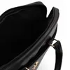 A close-up view of the interior of a black bag, showing the lining and a zipper. Produktbild-Vorschau