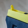 Close-up of a yellow and black measuring tool with markings. Produktbild-Vorschau