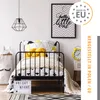A child's bedroom with a bed, a lamp, and wall art. Produktbild-Vorschau