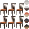 A set of six dining chairs with orange seats and dark brown wooden frames, arranged in two rows of three. Voir les images du produit