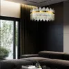 A modern living room with a large sectional sofa and a striking chandelier. Produktbild-Vorschau
