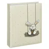 A photo album with a polka dot pattern and a cartoon bunny on a swing. Voir les images du produit