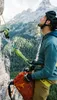 A climber is secured to a rock face, looking up at the mountains. Podgląd zdjęcia produktu
