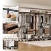 An open wardrobe system with clothes hanging and items stored on shelves and in drawers. Produktbild-Vorschau