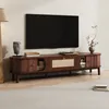 A modern living room with a TV stand and a large television mounted on the wall. Produktbild-Vorschau