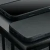 Close-up view of a black leather phone case with embossed branding. Anteprima dell’immagine prodotto