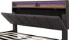 A close-up view of a bed frame's headboard, showing its upholstered panels and integrated LED lighting. Náhľad obrázku produktu