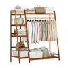 A wooden garment rack with shelves and hanging clothes. Voir les images du produit