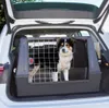 A dog is inside a car trunk in a pet carrier. Anteprima dell’immagine prodotto
