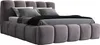 A modern upholstered bed with a tufted headboard and frame, shown with pillows and a blanket. Produktbild-Vorschau