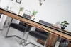 A dining room setting with a large wooden table and chairs, a sideboard, and decorative items. Produktbild-Vorschau