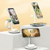 Three white charging stands for phones, watches, and earbuds are displayed on white pedestals against a light yellow background. Produktbild-Vorschau