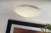 A ceiling light fixture is shown mounted on a white ceiling, with a framed picture visible below it. Produktbild-Vorschau