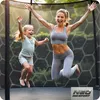 A mother and daughter are jumping on a trampoline outdoors. Produktbild-Vorschau