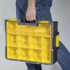 A person is holding a black and yellow storage case with multiple compartments. Produktbild-Vorschau