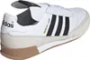 A close-up side view of a white Adidas sneaker with black stripes and tan accents. Produktbild-Vorschau