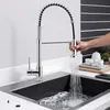 A person is using a kitchen faucet to fill a sink with water. Produktbild-Vorschau