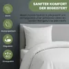A white pillow and duvet on a bed, with icons and text describing product features. Produktbild-Vorschau