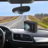 A black car air cooler sits on the dashboard of a car driving down a highway. Podgląd zdjęcia produktu