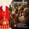 A grandfather and child are decorating a Christmas tree, with a toy train in the foreground. Produktbild-Vorschau