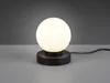 A black table lamp with a white glass globe shade sits on a gray surface against a gray background. Produktbild-Vorschau