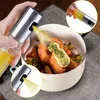 A hand is spraying oil onto a roasted chicken in a pot. Anteprima dell’immagine prodotto