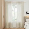 A bedroom scene with sheer beige curtains covering a window, a wooden wardrobe, and a bed with a headboard and pillows. Produktbild-Vorschau
