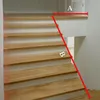 A staircase with wooden steps and a red line indicating a measurement or angle. Náhľad obrázku produktu