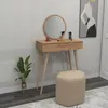 A vanity table with a mirror, stool, and plant in a room setting. Produktbild-Vorschau
