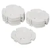 Three stacks of white plastic socket covers are arranged on a white background. Produktbild-Vorschau