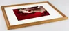 A framed picture of a woman with red flowers. Produktbild-Vorschau