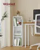 A white three-tier bookshelf with books, headphones, and a vase is placed next to a desk with a computer monitor and a chair in a room. Produktbild-Vorschau