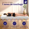 A woman lying on a mattress, with text and diagrams explaining its features. Voir les images du produit