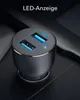 A close-up shot of a black car charger with two blue USB ports, plugged into a car's interior. Anteprima dell’immagine prodotto