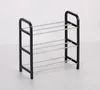 A black and silver shoe rack with four shelves. Produktbild-Vorschau