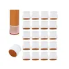 A collection of white silicone chair leg caps with brown felt bottoms, arranged neatly in rows on a white background, with one example of a chair leg with a cap on it to the left. A single cap is shown at the bottom left. Produktbild-Vorschau