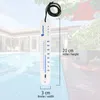 A thermometer floating in a swimming pool, with a house and trees in the background. Produktbild-Vorschau