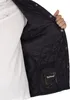 Close-up of the inside of a blue quilted jacket, showing the lining and a pocket with a Barbour logo. Produktbild-Vorschau