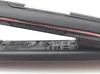 A close-up shot of the side of a black hair straightener with rose gold accents, showing buttons and regulatory markings on the underside. Náhľad obrázku produktu